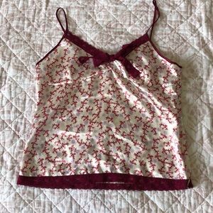 Satan spaghetti strap top with lace trims.